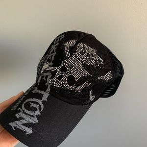 Black trucker hat with skull designs and rhinestones with adjustable str…